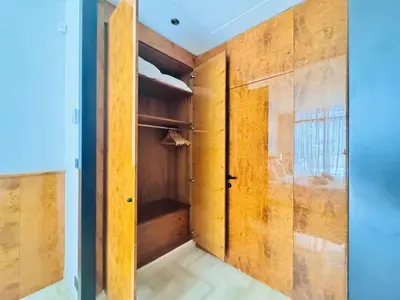 a room with a closet with wooden doors at Le Gray - Terrasse Centre Cannes Croisette & Palais in Cannes