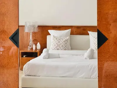 a bed with white sheets and pillows in a room at Le Gray - Terrasse Centre Cannes Croisette & Palais in Cannes
