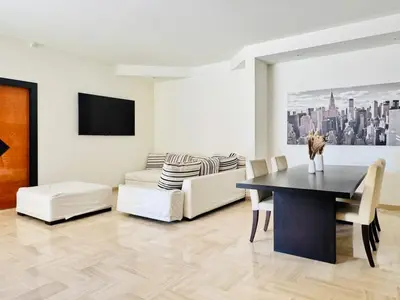 a living room with a table and a couch at Le Gray - Terrasse Centre Cannes Croisette & Palais in Cannes