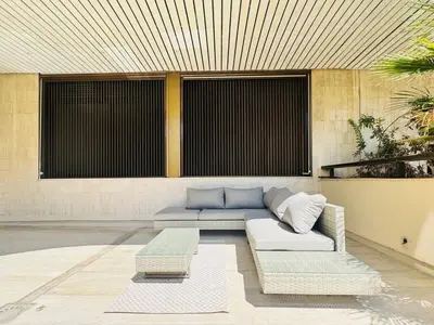 a living room with a couch and a table at Le Gray - Terrasse Centre Cannes Croisette & Palais in Cannes