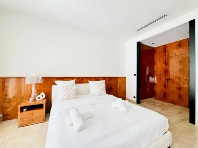 two beds in a room with white sheets at Le Gray - Terrasse Centre Cannes Croisette & Palais in Cannes