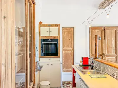 a kitchen with a sink and a microwave at L'olivine - Paisible Loft avec terrasse Cannes in Cannes