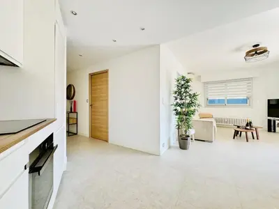 a living room with a sliding door in a house at Le Stanislas - Appartement 2 Chambres Terrasse in Cannes