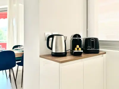 a kitchen with a coffee maker and a toaster on a counter at Le Stanislas - Appartement 2 Chambres Terrasse in Cannes