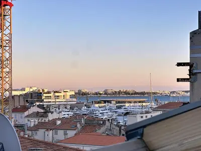 a view of a city with boats in a harbor at 31m2 - appartement en plein centre-ville in Cannes