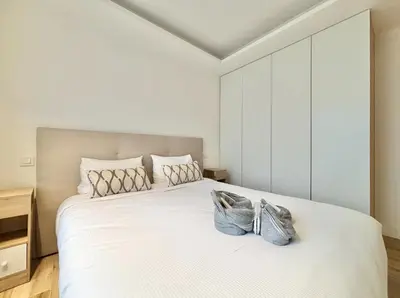 a bedroom with a large white bed with two bags on it at Cannes - 2 bedrooms & 2 bathrooms apartment - 24P1 in Cannes