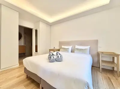 a bedroom with a large white bed with shoes on it at Cannes - 2 bedrooms & 2 bathrooms apartment - 24P1 in Cannes