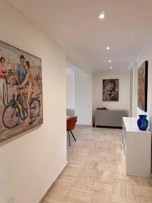a room with a painting of a woman riding a bike at BELLE PLAGE, deux chambres proche mer in Cannes