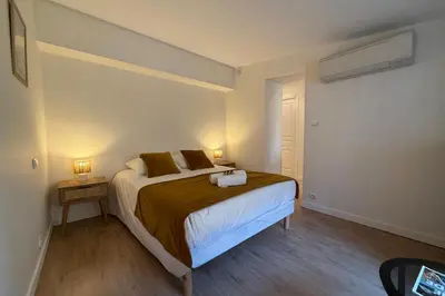 a bedroom with a bed with two towels on it at Central studio with real bed near the Palais in Cannes