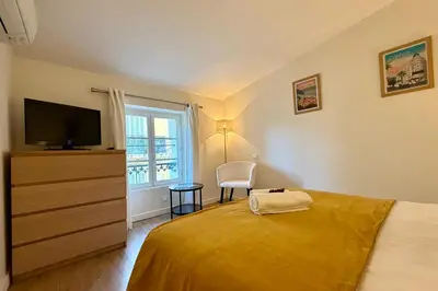 a bedroom with a bed with a television and a dresser at Central studio with real bed near the Palais in Cannes