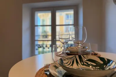 a table with two wine glasses on top of it at Central studio with real bed near the Palais in Cannes