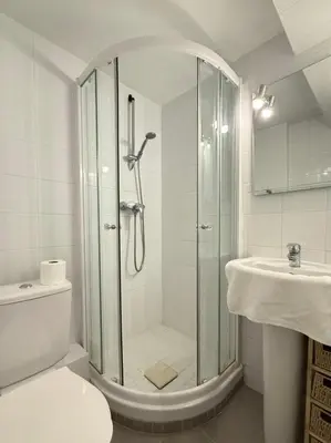 a bathroom with a shower and a toilet and a sink at Central studio with real bed near the Palais in Cannes