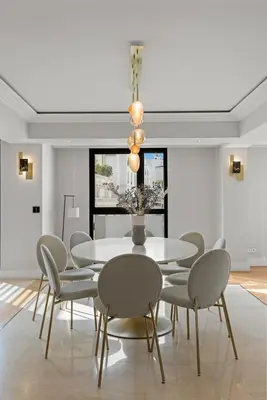 a dining room with a white table and chairs at Stunning 3BR apartment Carlton Riviera Croisette in Cannes