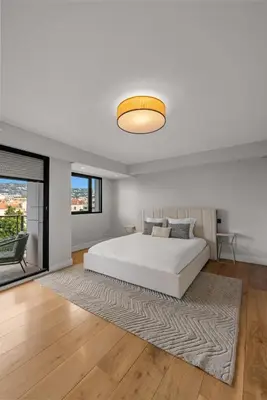 a bedroom with a white bed and a large window at Stunning 3BR apartment Carlton Riviera Croisette in Cannes
