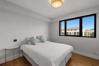 a white bedroom with a bed and a window at Stunning 3BR apartment Carlton Riviera Croisette in Cannes