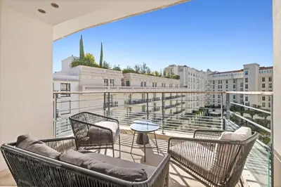 a balcony with chairs and a table on a building at Stunning 3BR apartment Carlton Riviera Croisette in Cannes