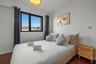a bedroom with a large white bed with a window at Sublime 2BR apartment Carlton Riviera Croisette in Cannes