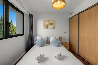 a bedroom with a large white bed with a window at Sublime 2BR apartment Carlton Riviera Croisette in Cannes