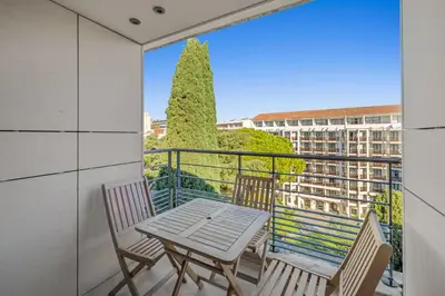 a table and chairs on a balcony with a view at Sublime 2BR apartment Carlton Riviera Croisette in Cannes