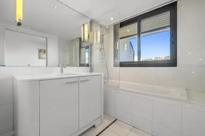 a white bathroom with a sink and a tub and a window at Sublime 2BR apartment Carlton Riviera Croisette in Cannes