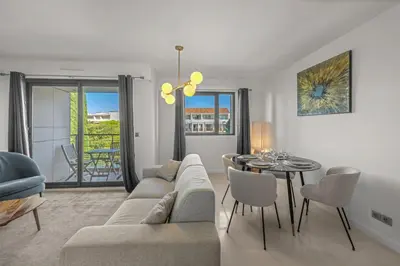 a living room with a couch and a table at Sublime 2BR apartment Carlton Riviera Croisette in Cannes