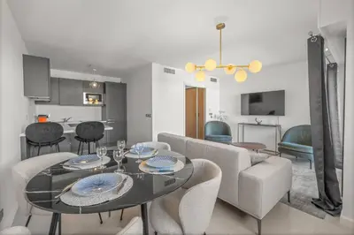 a living room with a table and a couch at Sublime 2BR apartment Carlton Riviera Croisette in Cannes