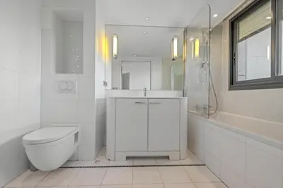 a white bathroom with a toilet and a sink at Sublime 2BR apartment Carlton Riviera Croisette in Cannes