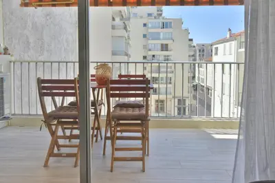 a table and chairs on a balcony with a view at 1-Br with Terrace Carré dOr Walking Distance to the Beaches in Cannes