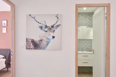 a bathroom with a picture of a deer on the wall at 1-Br with Terrace Carré dOr Walking Distance to the Beaches in Cannes