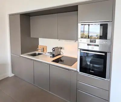 a kitchen with stainless steel appliances and a sink at Ref DUNES3 by Palmes d Or Properties in Cannes