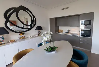 a kitchen with a table and chairs and a mirror at Ref DUNES3 by Palmes d Or Properties in Cannes