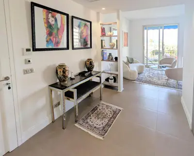 a living room with a table with vases on it at Ref DUNES3 by Palmes d Or Properties in Cannes