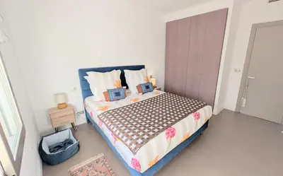 a bedroom with a bed with two monitors on it at Ref DUNES3 by Palmes d Or Properties in Cannes