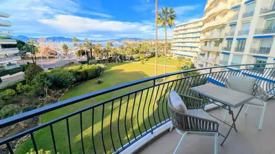 a balcony with a table and chairs and a park at Ref DUNES3 by Palmes d Or Properties in Cannes
