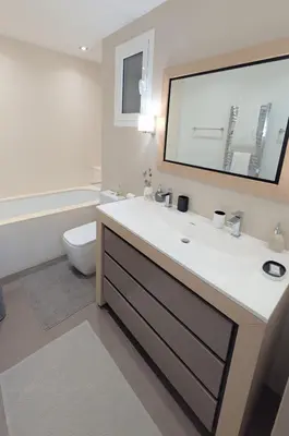 a bathroom with a sink and a toilet and a mirror at Ref DUNES3 by Palmes d Or Properties in Cannes