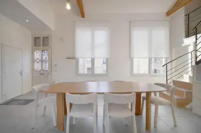 a dining room with a table and chairs at MIPIM Walk-to-Palais 100sqm Loft 2 Ensuite Suites 3 Bathrooms Terrace Business Ready in Cannes