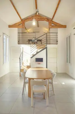 a kitchen with black cabinets and a microwave at MIPIM Walk-to-Palais 100sqm Loft 2 Ensuite Suites 3 Bathrooms Terrace Business Ready in Cannes