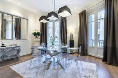 a dining room with a glass table and chairs at 120 m2 GRAND STANDING CENTRE PROCHE PALAIS FESTIVALS in Cannes