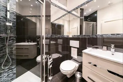 a bathroom with a toilet and a sink and a shower at 120 m2 GRAND STANDING CENTRE PROCHE PALAIS FESTIVALS in Cannes