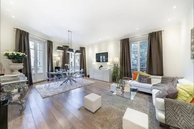 a living room with a couch and a table at 120 m2 GRAND STANDING CENTRE PROCHE PALAIS FESTIVALS in Cannes