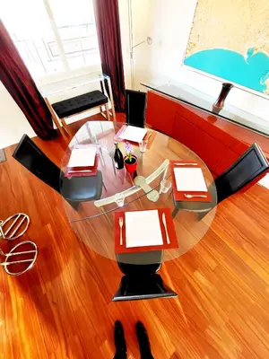 a living room with a glass table and chairs at Villa St Marc - Standing Presta in Cannes
