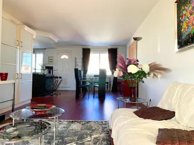 a living room with a couch and a table at Villa St Marc - Standing Presta in Cannes