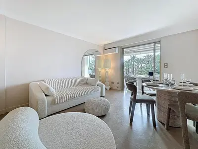 a living room with a couch and a table at 38 m2 - Suite de luxe, terrasse vue mer, Croisette in Cannes