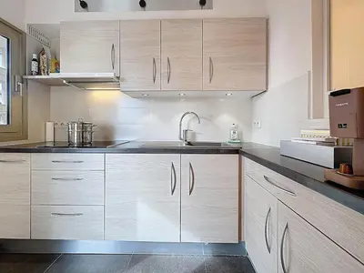 a kitchen with white cabinets and a sink at 38 m2 - Suite de luxe, terrasse vue mer, Croisette in Cannes