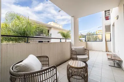 a balcony with wicker chairs and a table at Spacious Apartment a c 1BR 4P – With Pool in Cannes