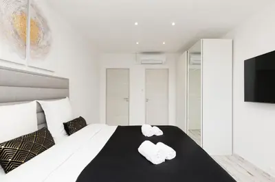 a bedroom with a bed with two towels on it at Romy YourHostHelper in Cannes