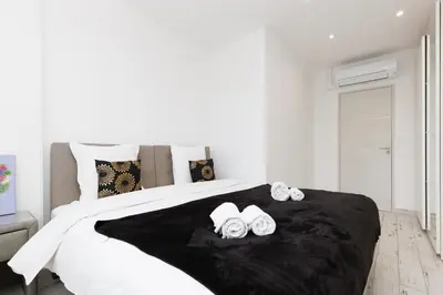 a bedroom with a large bed with two towels on it at Romy YourHostHelper in Cannes