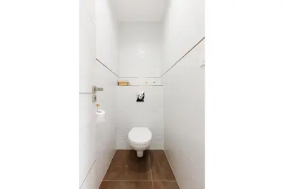 a white bathroom with a toilet in the corner at Romy YourHostHelper in Cannes