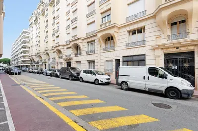 a white van parked in front of a building at Romy YourHostHelper in Cannes