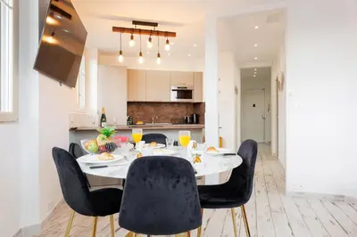 a dining room with a table and chairs at Romy YourHostHelper in Cannes